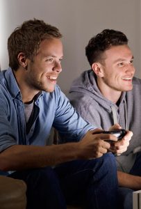 Young men playing video game
